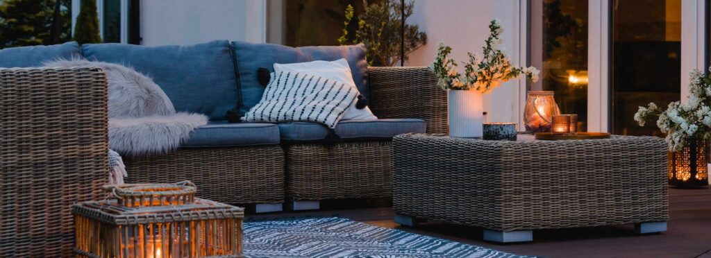 An angle shot of an evening time lounge room with warm light coming from feature lamps positioned around the space.