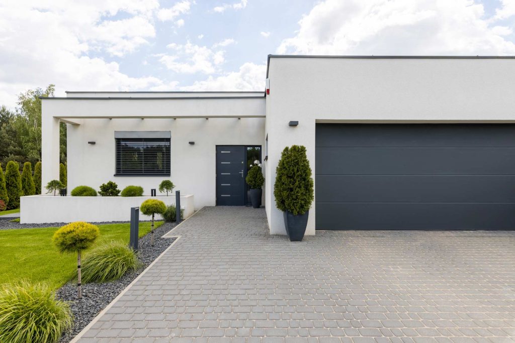 A sleek, modern house with a garage and driveway | Featured Image for the Carport Builders & Garage Builders service landing page