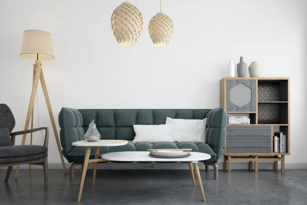 Modern living room with a green couch, grey flooring and white walls | Image for the Rooming House Builders page.